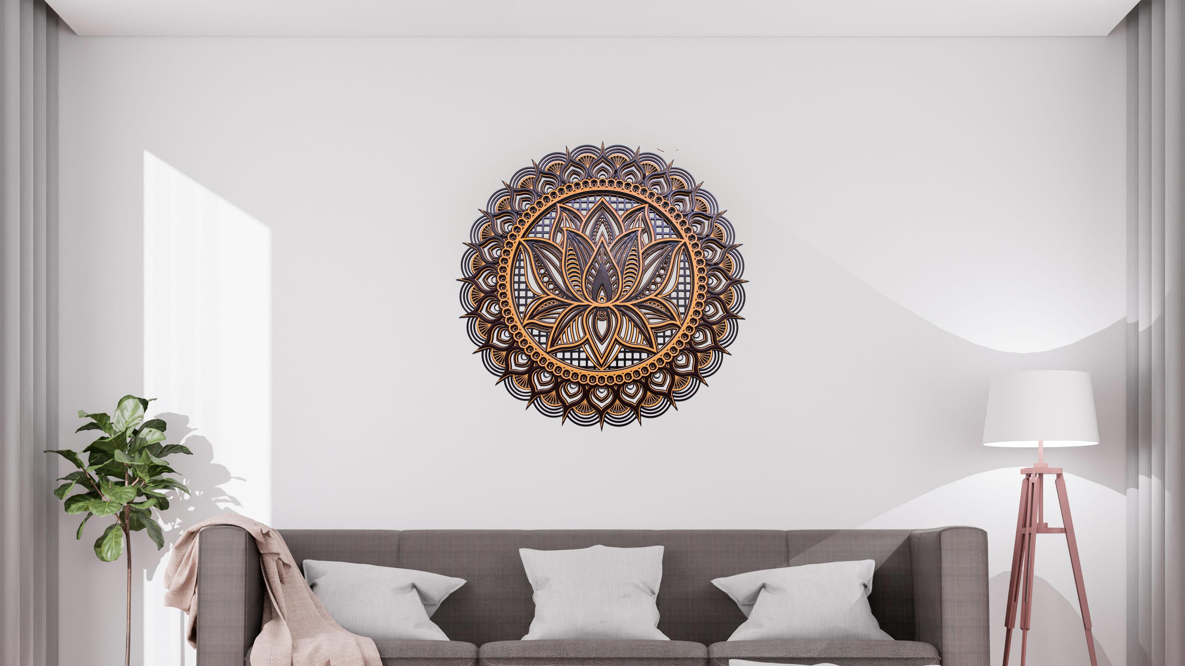 Close-up of brown mandala with bronze lotus design and fine details.