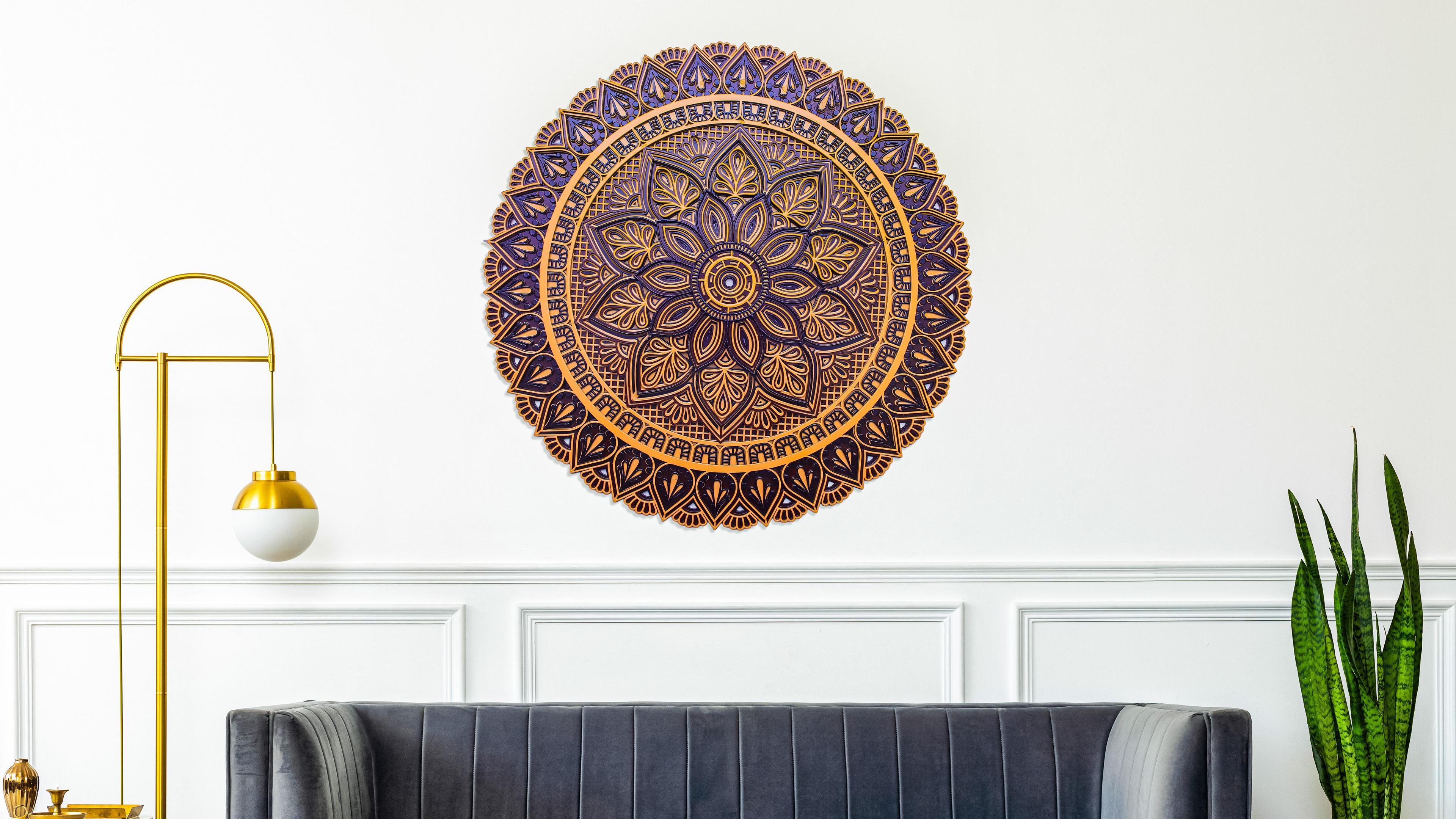 Dark brown and gold mandala with sophisticated floral carvings, top-down view.